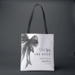 She’s Tying The Knot Black Bow Bridal Shower Tote Bag<br><div class="desc">Celebrate the bride-to-be with this She’s Tying The Knot Black Bow Bridal Shower Tote Bag, designed with a chic coquette-inspired black bow and elegant modern typography. Perfect for bridal showers, bachelorette celebrations, and wedding events, this stylish tote makes a thoughtful gift for the bride, bridesmaids, or guests. Ideal as a...</div>