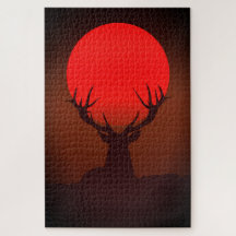 Silhouet van een hert met vurige rode zonsondergan