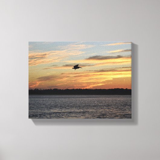 Silhouet van pelikaan vliegen over de rivier canvas afdruk (Voorkant)