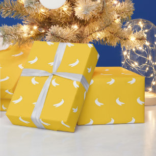 Silhouetten van kleine witte bananen op geel cadeaupapier