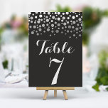 Silver Confetti Elegant Zwart Tafelnummer<br><div class="desc">Voeg een vleugje glamour en glans toe aan uw huwelijksreceptie met deze elegante tafelnummers. Deze kaarten hebben een stoere zwarte achtergrond met een cascade van glinsterende zilveren confetti en creëer een moderne en chique uitstraling. Personaliseer eenvoudig met uw tafelnummers voor een samenhangende en onvergetelijke tafelsetting.</div>
