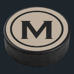 Simple Black Monogram Initiaal Hockey Puck<br><div class="desc">Het minimale monogrammed ontwerp kenmerkt een zwart en beige monogram medallion in een witte klassieke bloktypografie. Pas uw initiaal aan.</div>