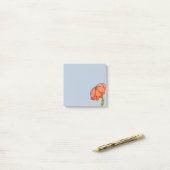 Sinaasappelbloem met blauwe achtergrond post-it® notes (Op bureau)