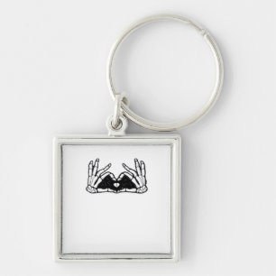 Skelet in de handen van een hart sleutelhanger