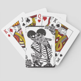 Skeletverdichtingskoppel op een set pokerkaarten