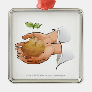 Sluiting van iemands handen die zaailingen vasthou metalen ornament