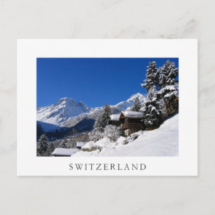 Sneeuw bedekte blokhutten in Zwitserland Briefkaart