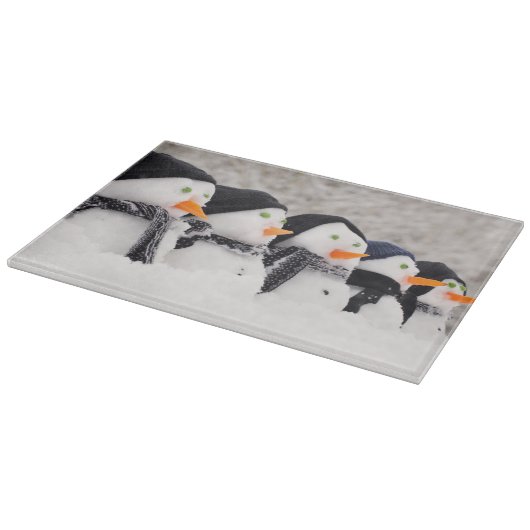 Sneeuwmannen sluiten op rij snijplank (Hoek)