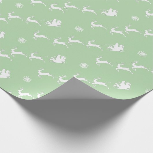 Sneeuwvlok en kerstman met slee op lichtgroen cadeaupapier (Hoek)