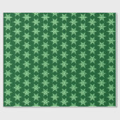 Sneeuwvlokken, bleke groene kristallen op donkergr cadeaupapier (Vlak)
