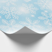 Sneeuwvlokken en lichten op blauw cadeaupapier (Hoek)