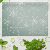 Sneeuwvlokken met een achtergrond van lichtgroen theedoek (Gevouwen)
