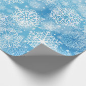 Sneeuwvlokken op blauw cadeaupapier (Hoek)
