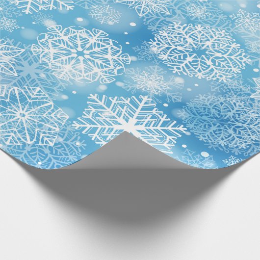 Sneeuwvlokken op blauw cadeaupapier (Hoek)