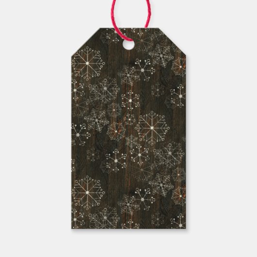 Sneeuwvlokken op donker hout cadeaulabel