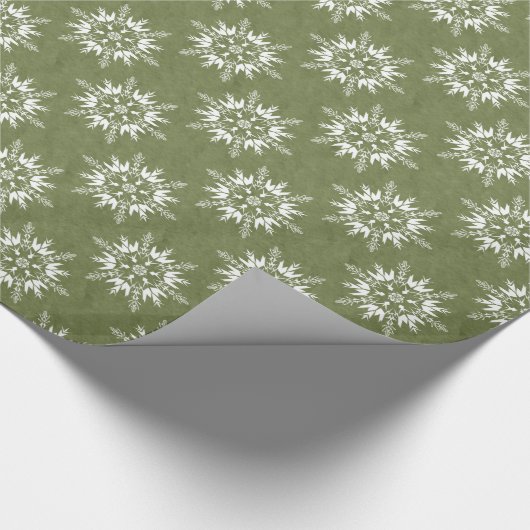 Sneeuwvlokken op groen cadeaupapier (Hoek)