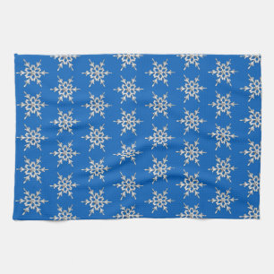 Sneeuwvlokken, zilverkristallen op kobalblauw theedoek