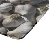 Snijplank van glas met oogst knoflook (Hoek)