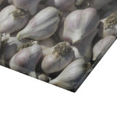 Snijplank van glas met oogst knoflook (Hoek)
