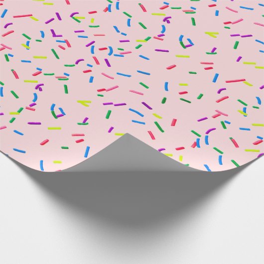 Snoep sprinken op roze cadeaupapier (Hoek)