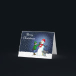 Snowman Building Feestdagen Kaart<br><div class="desc">De jongen heeft een sneeuwpop gebouwd waar zijn hond op staat en urineert terwijl de jongen de sneeuwman een wortelneus geeft.</div>