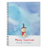 Snowman die met vrolijk kerstfeest zwaait en gliml notitieboek (Voorkant)