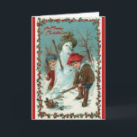 Snowman en Snowball Vintage-kerstkaart Feestdagen Kaart<br><div class="desc">Deze feestelijke wenskaart is voorzien van een prachtig kunstmatig afbeelding van twee jongens die in de sneeuw spelen. Een jongen bouwt gelukkig een sneeuwman, terwijl de ander sneeuwballen maakt. Het afbeelding is omhuld in overeenkomend rood. Op de voorkant van de kaart staat "Een prettige kerst" en de tekst in de...</div>