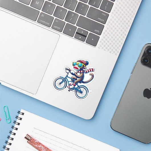 Sock Monkey Riding Bike Sticker (Laptop met iPhone)