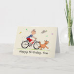 Son Birthday Cartoon van een Boy Riding Bike Kaart<br><div class="desc">Dit is een amusante kaart voor iemand die zijn zoon op zijn verjaardag geeft. Het is een cartoon karikatuur van een jongen op zijn fiets achter een glimlachende bruine hond die ronddraait, omringd door vlinders, en een vogel. De jonge jongen draagt rode korte broeken en sokken, een blauw t shirt...</div>