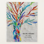 Speciaal uitgeruste levenscoach planner<br><div class="desc">Deze unieke planner is versierd met een afbeelding van een mozaïekboom, gemaakt van kleine stukjes helder gekleurd glas. Eenvoudig aan te passen met jouw naam, beroep en het jaar. Gebruik de optie Verdere wijzigingen aanpassen om de tekstgrootte, stijl of kleur te wijzigen als u dat wenst. Omdat we ons eigen...</div>