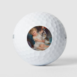 Speeltijd: Meisje speelt met haar dichter Kitten Golfballen