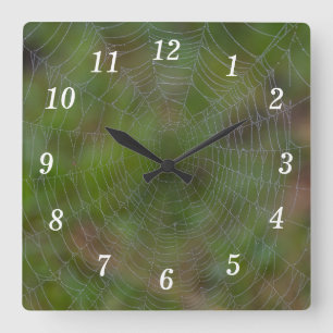 Spiderweb met druppeltjes wandklok