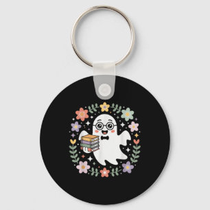 Spook met boeken omringd door herfstbloemen en sleutelhanger