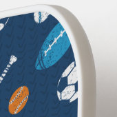 Sportuitrusting op donkerblauw pickleball paddle (Links Detail)