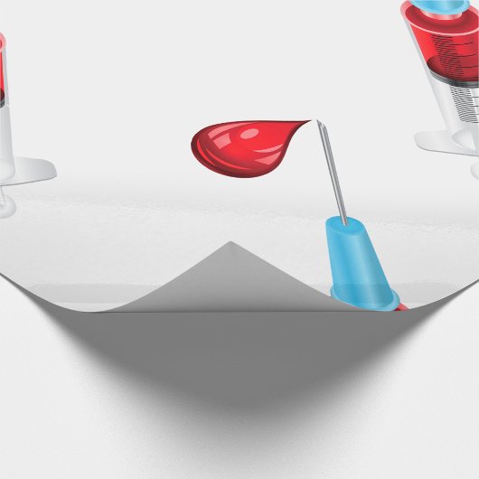 Spuit met een rode druppel cadeaupapier