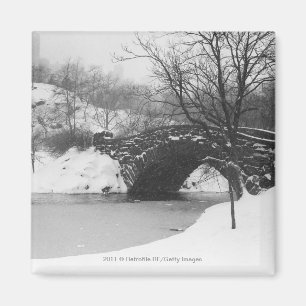 Stenen brug over een met sneeuw bedekte rivier magneet
