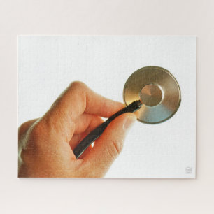 Stethoscoop in een hand voor een ziekenhuis sfeer. legpuzzel