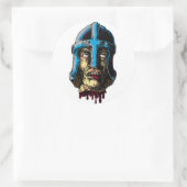 sticker in afgehakt hoofd (Tas)