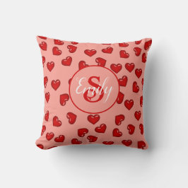 stijlvol rood hartpatroon op perzikroze monogramme kussen