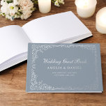 Stoffig Blauw Zilver Bloemen Vintage bruiloft Gastenboek<br><div class="desc">Leg herinneringen vast in tijdloze elegantie met ons Victoriaans Floral Wedding Folie Guest Book. Met ingewikkelde bloemige design en luxe folie accenten straalt dit gastenboek klassieke charme en sophisticatie uit. Perfect voor het bewaren van oprechte berichten van uw dierbaren, het combineert oude wereld schoonheid met modern vakmanschap. De hoogwaardige materialen...</div>