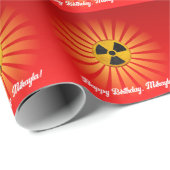 Stralingssymbolen op rood cadeaupapier (Rol Hoek)