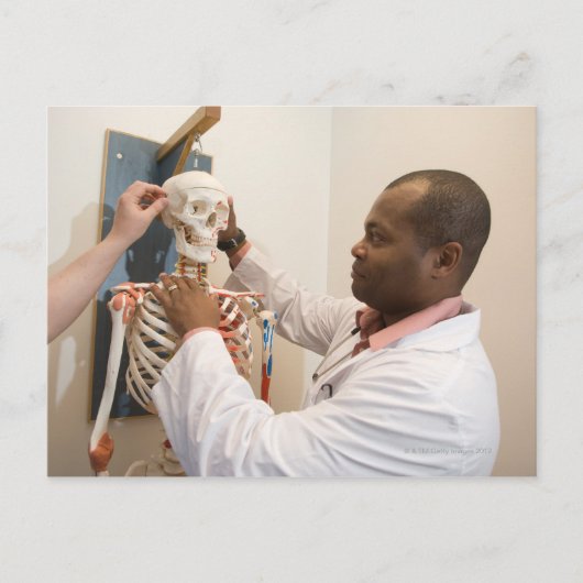 Studentenartsen bestuderen anatomie op een skelet briefkaart (Voorkant)