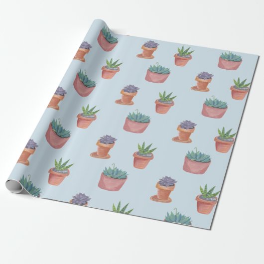 Succulte en cacti op blauw cadeautje tegen achterg cadeaupapier (Uitgerold)