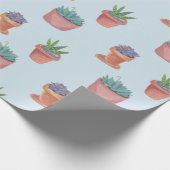 Succulte en cacti op blauw cadeautje tegen achterg cadeaupapier (Hoek)