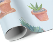 Succulte en cacti op blauw cadeautje tegen achterg cadeaupapier (Rol Hoek)