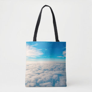 Sunrise boven wolken uit het raam van het vliegtui tote bag