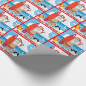 Surfende kerstman op doorsnee kerst cadeaupapier (Hoek)