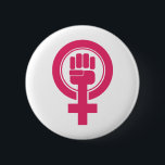 Symbool vrouwenvuist weerstaan ronde button 5,7 cm<br><div class="desc">Dit symbool is voorzien van een roze vuist die in het gendersymbool van het vrouw is opgetild.</div>