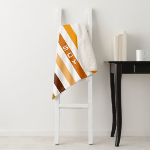 Taan bruin oranje verticale strepen monogram sherpa deken