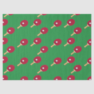 Tafeltennisracket en bal op groen tissuepapier